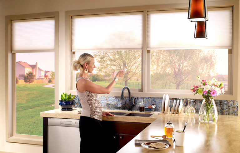 Woman using a remote to control her smart home